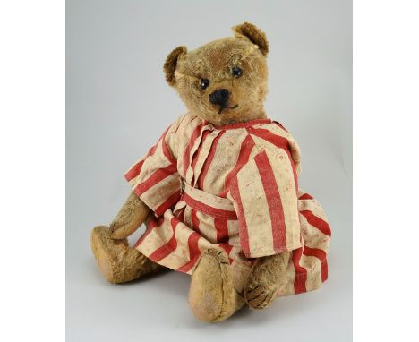 A golden mohair Steiff Teddy bear, German circa 1909, with black boot button eyes, stitched nose and mouth, swivel head and j