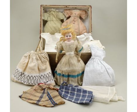 A fine bisque head B.S fashion doll with trunk and clothing, French circa 1870, the pale bisque head with blue/grey fixed gla