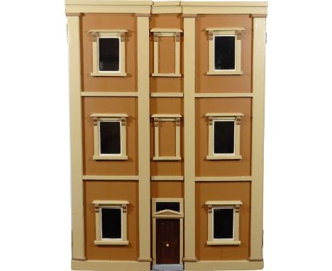 A painted wooden town dolls house, English circa 1890, the brown and cream exterior with panelled front door to centre, six g