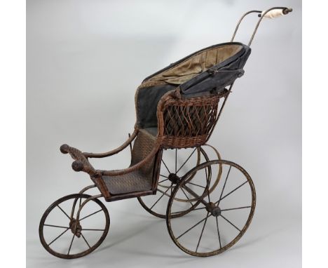 A Victorian sprung dolls pram, English, with three metal spoke wheels, wicker carriage and foot-well, oilcloth hood and white