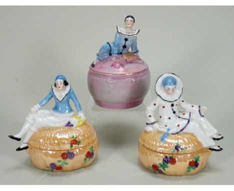 Glazed china Pierrot and Pierrette dressing table boxes, 1920s, seated figures on matching lids and bases, Pierrot in white w