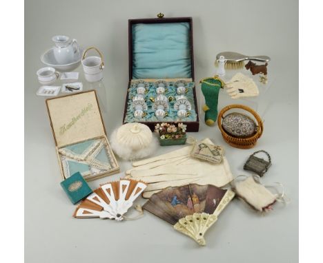 A collection of miniature dolls accessories, including a boxed set of three blue handkerchiefs, two decorative fans, needle w