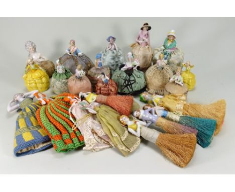 Collection of glazed china Half-Dolls, mainly German 1900-20s, twelve mounted on pin-cushion bases, five mounted on brushes, 