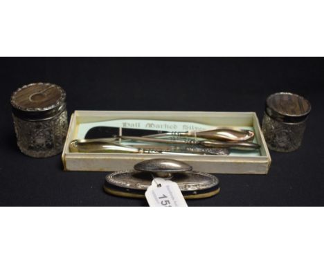 A graduated pair of cut glass and silver topped dressing table jars, engine turned line engraved tops, Birmingham 1913;  a si