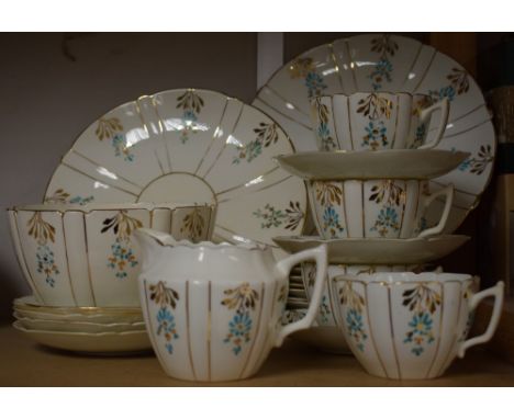 A part tea service in white china, decorated turquoise sprigs, gilded, twenty four pieces to include four cups, seven saucers