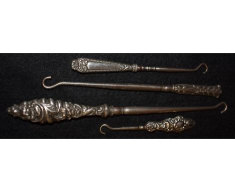 Four silver handled button hooks