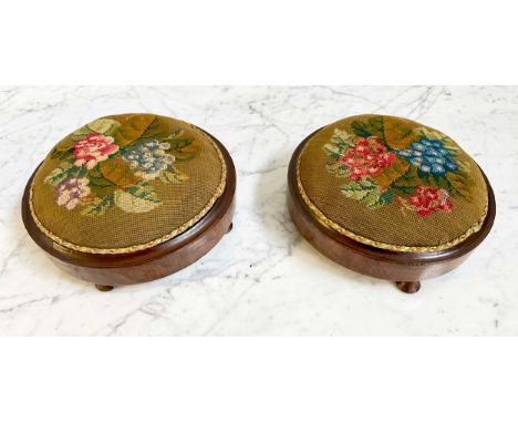 FOOTSTOOLS, a pair, Victorian figured walnut circular and footed with tapestry cushions, 28cm W. (2)