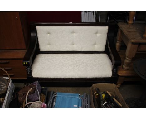 A mahogany cream upholstered bench 