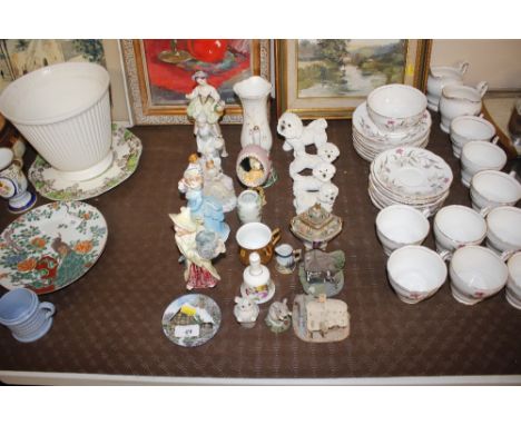 A collection of model cottages, various porcelain figures, dog ornaments etc.