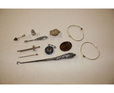 A silver handled button hook; another silver handled item; a white metal thimble; and other small jewellery items 