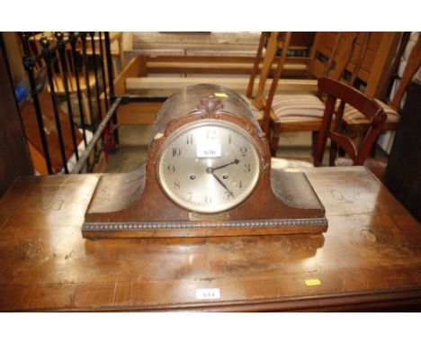 An oak cased two hole mantel clock with presentation plaque 