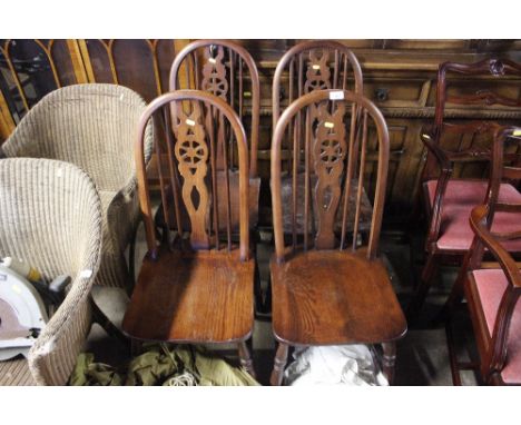 A set of four Old Charm stick and wheel back chairs