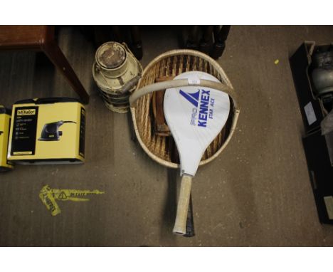 A wicker carrying basket and contents of tennis rackets and a metal candle lantern
