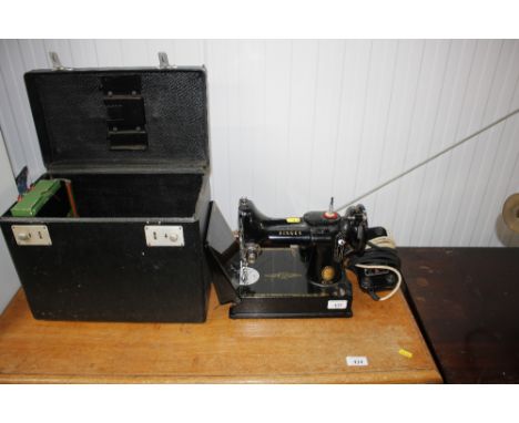 A Singer 221 K sewing machine and carrying case - sold as a collectors item