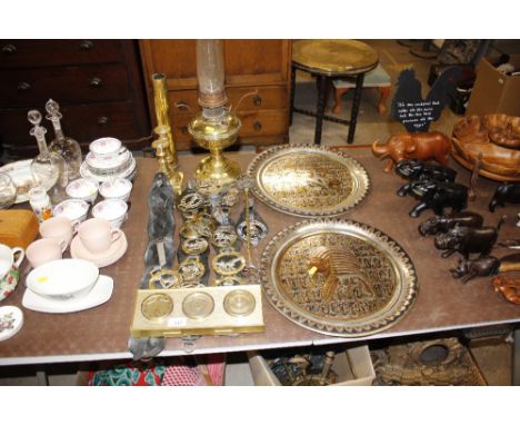 A brass oil lamp; quantity of horses brasses; toasting fork; barometer set; pair of candle sticks; shell case etc 