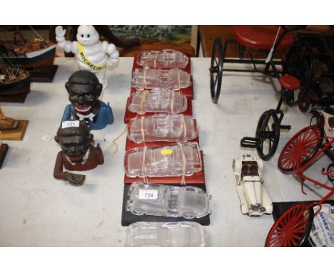 Seven glass model cars 