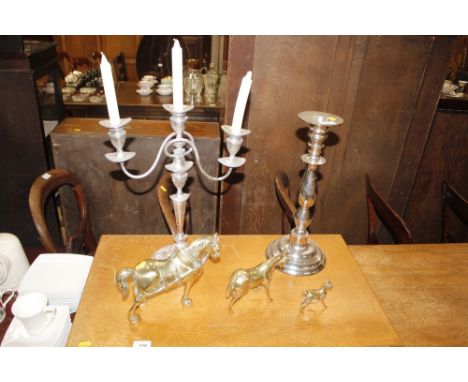 A plated candelabra; a large plated baluster candle stick and three brass horse ornaments  