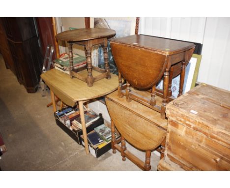 A Formica topped table; an oak gate leg dining table; an oak coffee table and a circular elm and oak coffee table