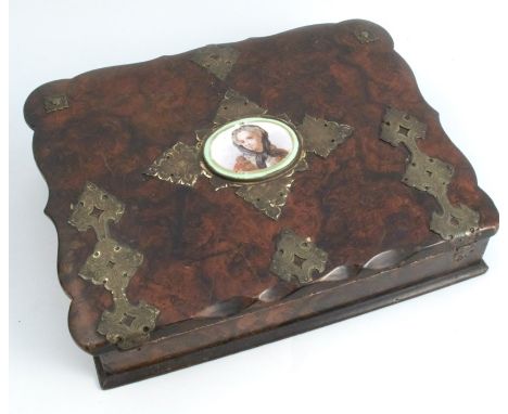 A 19th century painted papier mache writing box, the shaped rectangular box painted to resemble a burr wood, with engraved gi