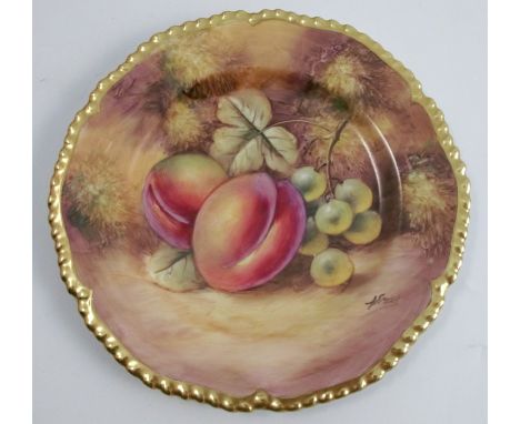 A Royal Worcester cabinet plate, decorated with fruit to a mossy background by J Smith, with a shaped gilt edge, diameter 6in
