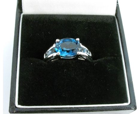 A 9 carat white gold blue topaz dress ring, finger size N, 2.9g gross