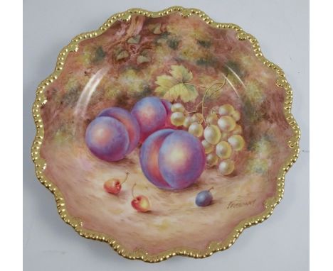 A Royal Worcester cabinet plate, decorated with fruit to a mossy background by Freeman, with a shaped gilt edge, diameter 9in