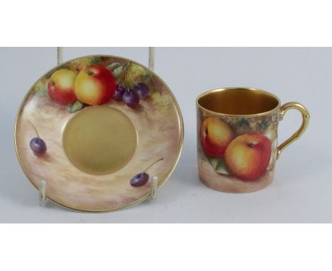 A Royal Worcester coffee can and saucer, the exterior of the can and the saucer painted with fruit to a mossy background by F