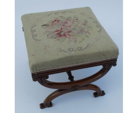 A 19th century mahogany stool, with tapestry seat raised on cross supports, 18ins x 18ins x 16ins