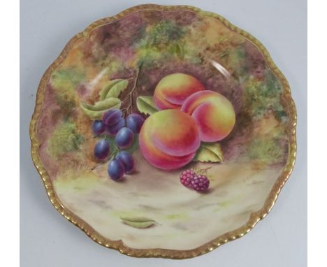 A Royal Worcester cabinet plate, decorated with fruit to a mossy background by H Henry, with a shaped gilt edge, diameter 9.5