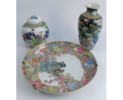 An Oriental porcelain shallow bowl, decorated with peacocks and flowers, diameter 11ins, together with a covered ginger jar a