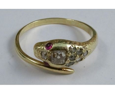 A diamond and ruby serpent ring, circa 1900, unmarked, the head set with eight diamonds and cabochon eyes, finger size U 1/2,