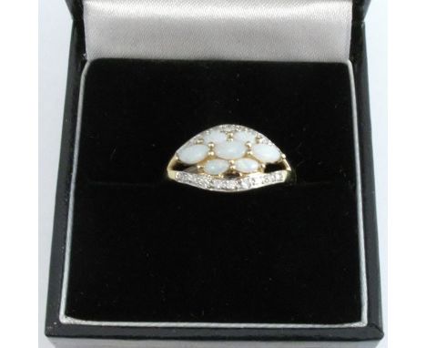 A 9 carat gold opal and diamond dress ring, finger size N 1/2, 2.2g gross