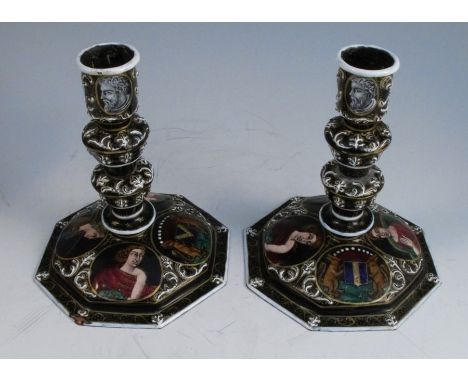A pair of 17th century style Limoges enamel candlesticks, with knoped stems and octagonal bases, decorated with Classical por