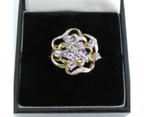 A 9 carat gold tanzanite and diamond cluster ring, finger size N, 3.8g gross
