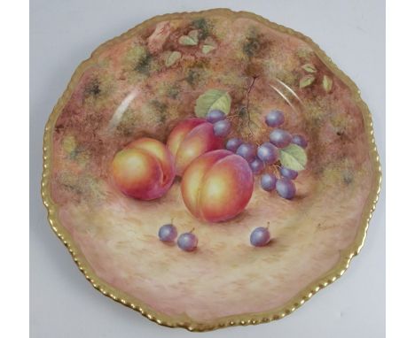 A Royal Worcester cabinet plate, decorated with fruit to a mossy background by Freeman, with a shaped gilt edge, diameter 10.