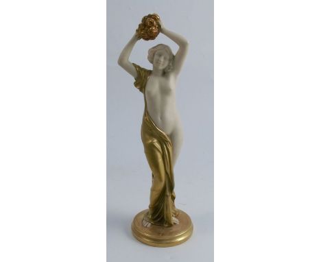 A Royal Worcester gilded ivory figure, of a semi naked female holding gilded flowers over her head, modelled by Clemincin, mo