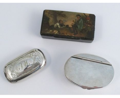A papier mache snuff box, the hinged cover painted with a rustic scene of two men smoking pipes, 7.8 cm long, together with t