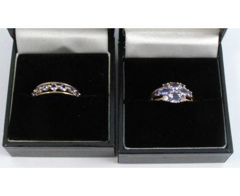 A 9 carat gold tanzanite set half hoop, finger size N 1/2 ; with a 9 carat gold eleven stone tanzanite cluster ring; 4.5g gro