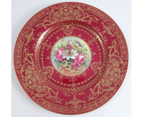 A Royal Worcester cabinet plate, the centre decorated with flowers by E Barker, with a large burgundy and gilt border, diamet