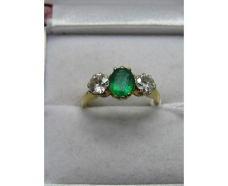 18CT YELLOW 3 STONE EMERALD &amp; DIAMOND RING, central oval cut emerald measuring in excess of 1ct, set between 2 transition