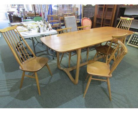 BLONDE ERCOL DINING SUITE, the refectory table of unusual stretchered base, with pair of Goldsmith comb back dining chairs &a