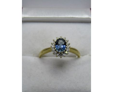 18CT YELLOW GOLD SAPPHIRE &amp; DIAMOND CLUSTER RING, central oval cut sapphire of good colour &amp; clarity surrounded by br