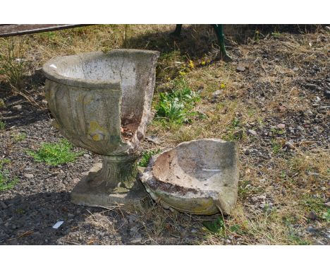 A large pedestal planter in need of restoration.