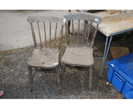 A pair of stick back kitchen chairs.