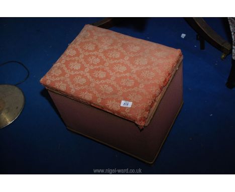 A small upholstered Ottoman and a lamp shade.