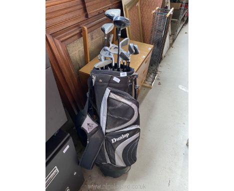 A Dunlop Golf Bag with 12 Right Handed Golf Clubs.