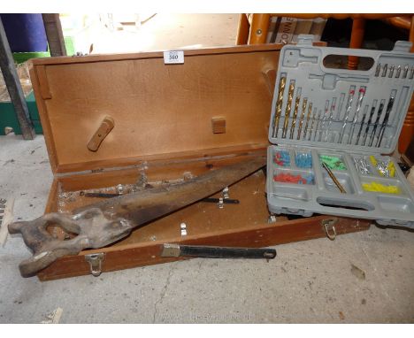 A wooden carpenter's tool box including set square, saw, drill and wall plug set.