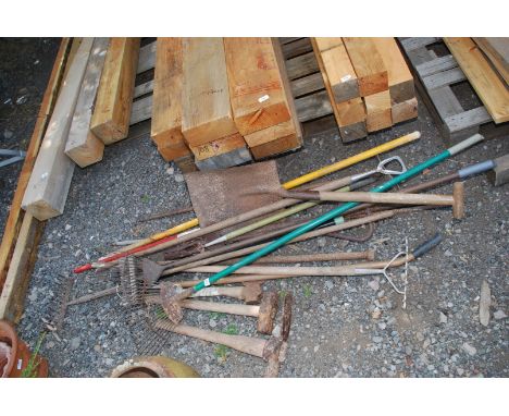A quantity of garden tools - small axe, rakes, shovel etc.