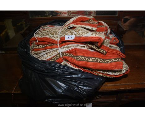 A bag of orange/cream curtains.