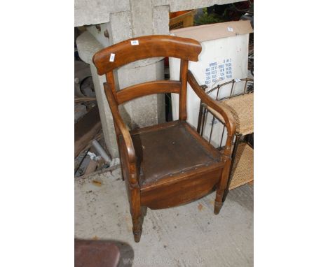 A commode chair complete with chamber pot and lid. 